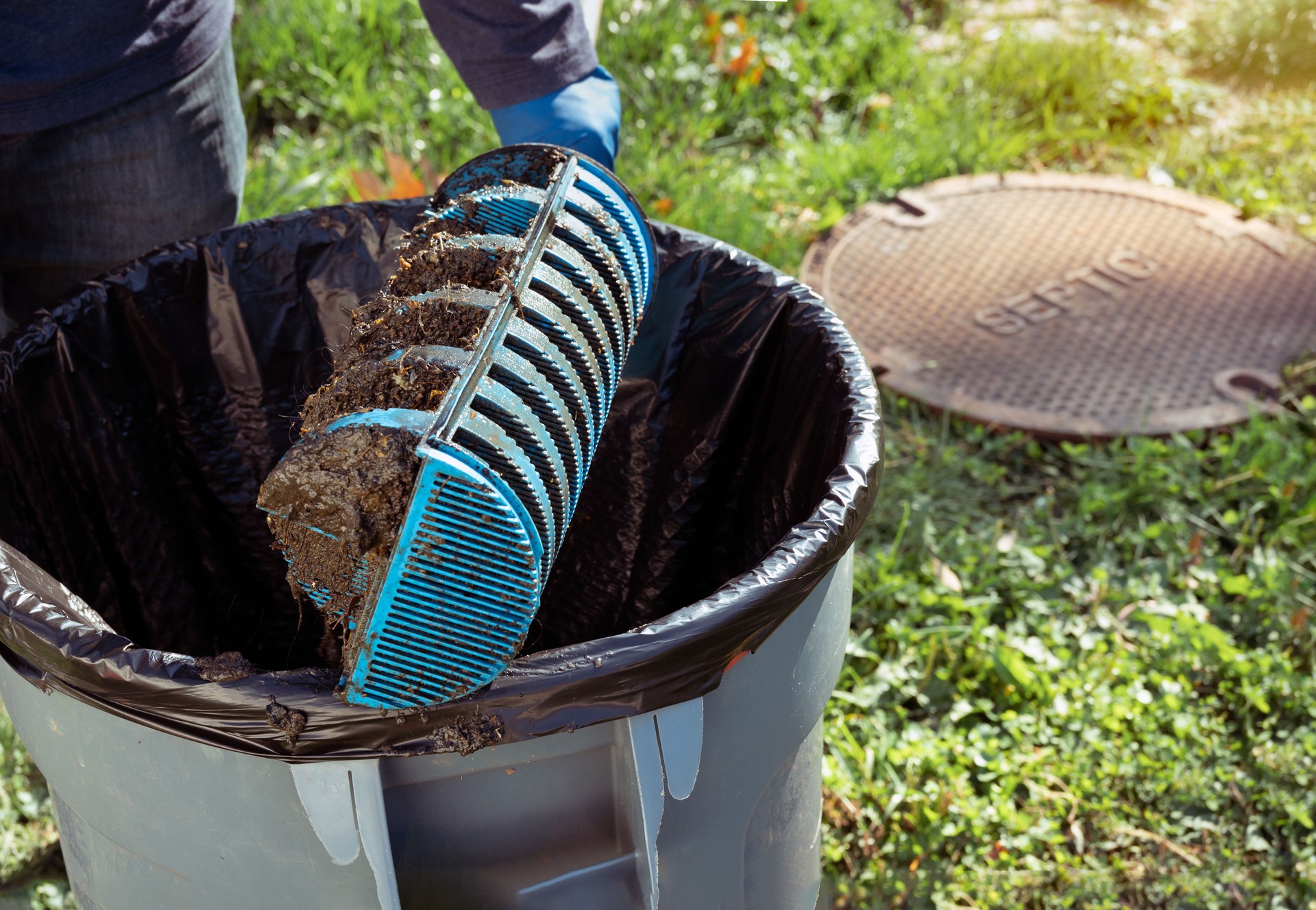 Man holding a Tuf - Tite filter of septic system tank and water wells.